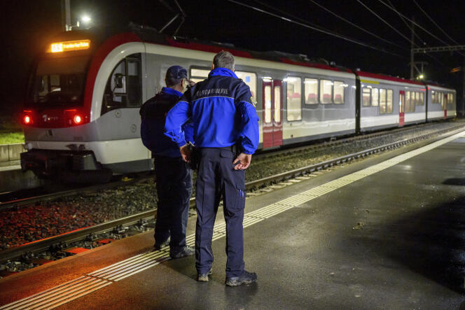 Des gendarmes devant un train dans lequel quinze personnes ont été prises en otage, dans le canton de Vaud, en Suisse, le 8 février 2024.