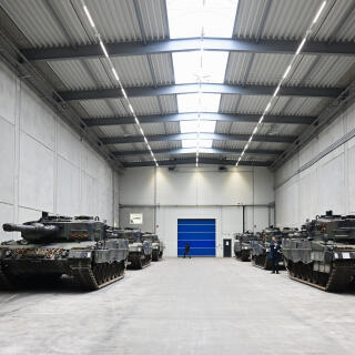 A view of Leopard 2 tanks at a production line as German Chancellor Olaf Scholz and Defence Minister Boris Pistorius visit the future site of an arms factory where weapons maker Rheinmetall plans to produce artilleries from 2025, in Unterluess, Germany, Monday Feb. 12, 2024. (Fabian Bimmer/Pool Photo via AP)