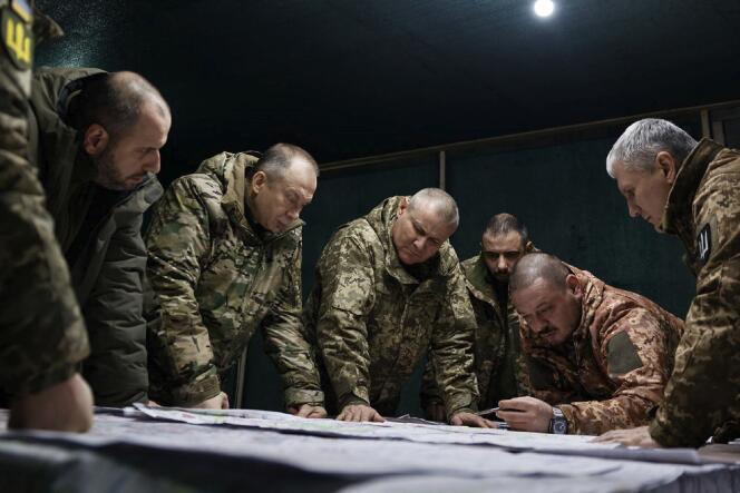 This handout photograph released on February 14, 2024, by the Press service of Ukrainian Armed Forces, shows Commander-in-Chief of the Armed Forces of Ukraine Oleksandr Syrsky (2nd L) and Ukraine's Defense Minister Rustem Umerov (L) visiting the frontline positions at an undisclosed location in eastern Ukraine.
