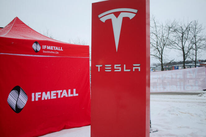 An IF metall tent stands next to a Tesla sign as workers picket outside of a Tesla service center in Upplands Vasby, north of Stockholm, Sweden, on December 15, 2023.