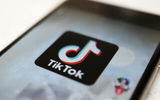 FILE - The TikTok logo is displayed on a smartphone screen, Sept. 28, 2020, in Tokyo, Japan. The European Union is looking into whether TikTok has broken the bloc’s strict new digital rules for cleaning up social media and keeping internet users safe. (AP Photo/Kiichiro Sato, File)