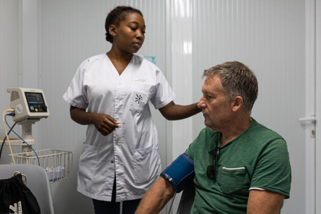 A caregiver attends to Patrick (who did not want to give his last name) suffering from dengue fever at the Tropical and Infectious Diseases Unit (UMIT) of Cayenne Hospital, Guyana, on February 20, 2024.