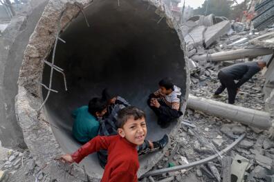 Children play in one of the fallen domes of the Al-Faruq mosque, levelled by Israeli bombardment in Rafah in the southern Gaza Strip on February 25, 2024, amid continuing battles between Israel and the Palestinian militant group Hamas. (Photo by MOHAMMED ABED / AFP)