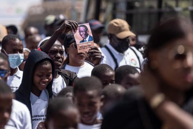 A supporter of Senegalese President Macky Sall and presidential candidate Amadou Bah holds a leaflet bearing a photo of the latter during a peace march in Dakar on March 3, 2024.
