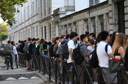 Students wait outside their high school on the first day of new academic year in Paris on September 4, 2023. Twelve million students go back to school in France on September 4, 2023. (Photo by Miguel MEDINA / AFP)