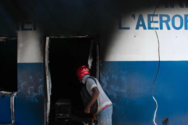 A man looking inside the police station at the airport in Port-au-Prince, Haiti, which had been set on fire by an armed gang. March 5, 2024.