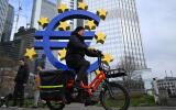 A cyclist passes the Euro logo in Frankfurt am Main, western Germany, on March 7, 2024 ahead of the European Central Bank (ECB) governing council meeting. - ALTERNATIVE CROP (Photo by Kirill KUDRYAVTSEV / AFP) / ALTERNATIVE CROP