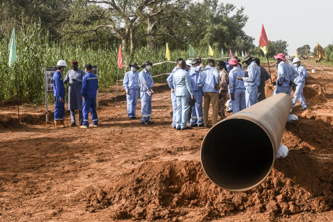 Workers from Niger and China are seen on the construction site of an oil pipeline in the region of Gaya, Niger, on October 10, 2022. 