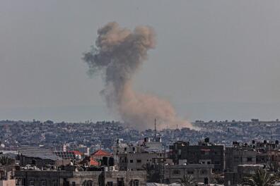 A picture taken from Rafah shows smoke billowing over Khan Yunis in the southern Gaza Strip during Israeli bombardment on March 11, 2024, amid ongoing battles between Israel and the Palestinian militant group Hamas. (Photo by SAID KHATIB / AFP)