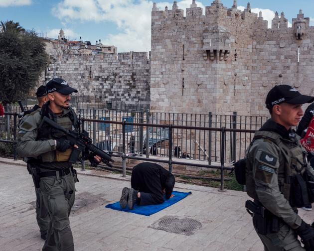A Palestinian prays at Damascus Gate in East Jerusalem on March 15, 2024.