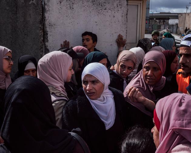 Palestinians wait at the Qalandiya checkpoint in the West Bank, unsure whether they will be able to attend the first Friday noon prayer of the month of Ramadan at the Al-Aqsa mosque in Jerusalem on March 15, 2024.
