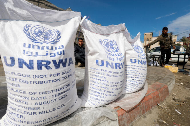 Displaced Palestinians wait to receive United Nations Relief and Works Agency (UNRWA) aid, in Rafah, in the southern Gaza Strip, on March 7, 2024.