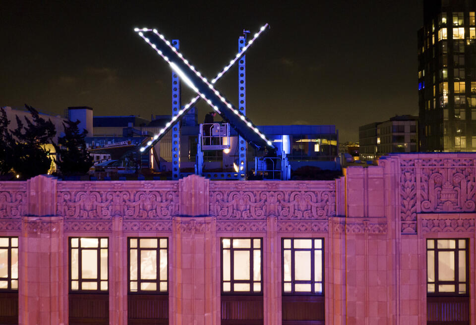FILE - Workers install lighting on an "X" sign atop the company headquarters, formerly known as Twitter, in downtown San Francisco, July 28, 2023. A federal judge has dismissed a lawsuit by Elon Musk's X Corp. against the non-profit Center for Countering Digital Hate, which has documented the increase in hate speech on the site since it was purchased by the Tesla owner. On Monday, March 25, 2024 U.S. District Court Judge Charles Breyer dismissed the suit, writing in his order that it was “unabashedly and vociferously about one thing" — punishing the nonprofit for its speech. (AP Photo/Noah Berger, File)