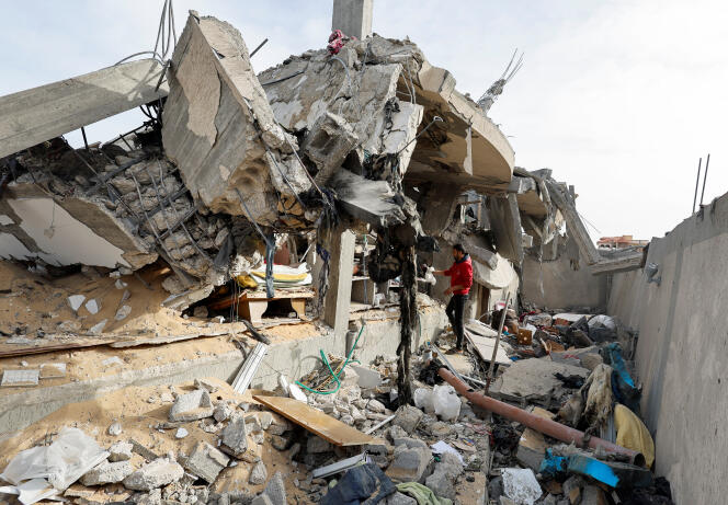 A Palestinian inspects the site of an Israeli attack on a house in Rafah, southern Gaza Strip, on March 26, 2024.