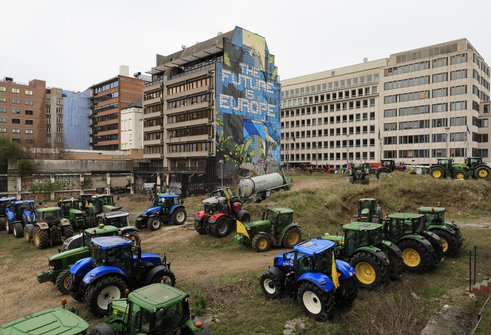 Farmers park their tractors near the European Council building in Brussels during a demonstration on Tuesday, March 26, 2024. Dozens of tractors sealed off streets close to European Union headquarters where the 27 EU farm ministers are meeting to discuss the crisis in the sector which has led to months of demonstrations across the bloc. (AP Photo/Geert Vanden Wijngaert)