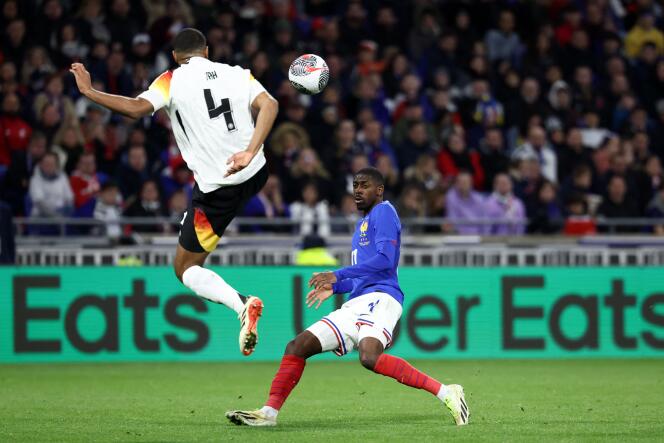 The number 4 on the Mannschaft jersey resembles the Nazi SS insignia.  Here, Jonathan Tah takes on Ousmane Dembele on March 23, 2024.