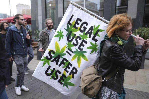 A person holds a banner during a demonstration in favor of the complete legalization of cannabis, in Leipzig, Germany, Monday, April 1, 2024. Marijuana campaigners in Germany lit celebratory joints on Monday as the country liberalized rules on cannabis to allow possession of small amounts. (Sebastian Willnow/dpa via AP)