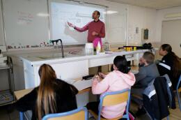 Nicolas Gaube (C), Life and Earth science (SVT) teacher, speaks with his students in his class at The Rene Cassin middle school in Agde, southern France, on November 6, 2023. Gaube is selected in the top 10 to receive the "Global Teacher Prize" awarded to the best teacher in the world. (Photo by Sylvain THOMAS / AFP)