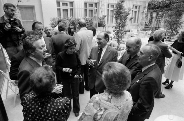 A rally of European socialist leaders, on May 25, 1979 in Paris, France. Mario Soares of Portugal (left), addresses Le Monde's director Jacques Fauvet (right). Onetime Le Monde journalist Claude Estier, now a Socialist politician, stands between Fauvet and François Mitterrand (center).