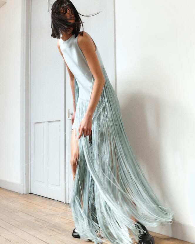 Asymmetric dress with wool fringe and faded denim, Acris, €3,250.  Shoes, Prada.