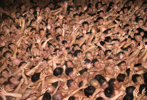 OKAYAMA, JAPAN - FEBRUARY 17: Approximately 9,000 men in loincloths try to snatch a lucky wooden stick during the 'Eyo' naked festival at Saidaiji Temple on February 17, 2024 in Okayama, Japan. The festival is held for the first time after coronavirus pandemic. The chief priest tossed a pair of 20-centimetre-long "shingi" sacred sticks from a window 4 meters above ground into the massive throng. Those who left the temple grounds holding the shingi are considered "lucky men" of this year. The Saidaiji-eyo festival, said to date to the Muromachi Period (1338-1573). (Photo by The Asahi Shimbun via Getty Images)