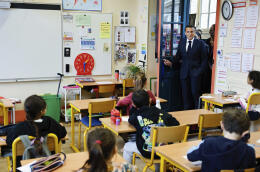 French President Emmanuel Macron enters a classroom during a visit to the Ecole primaire d'application Blanche and the Laboratoire académique de formation autisme (LAB9A), in Paris, Friday, April 5, 2024. (Ludovic Marin, Pool Photo via AP)