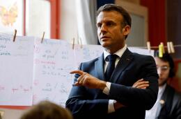 French President Emmanuel Macron stands in a classroom during a visit to the Ecole primaire d'application Blanche and the Laboratoire académique de formation autisme (LAB9A) in Paris on April 5, 2024. Three days after the National Autism Day, Macron visits LAB9A, a teacher training centre for autistic children recently set up by the Paris education authority, also meeting pupils and teachers at Blanche primary school, which has had an autism teaching unit (UEEA) since the start of the 2023 academic year. (Photo by Ludovic MARIN / POOL / AFP)