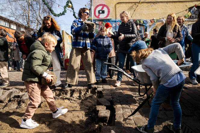 Families from the self-governed neighborhood of Christiania dig up the cobblestones of 'Pusher Street' to prevent drug dealers from gaining access, in Copenhagen, on April 6, 2024.