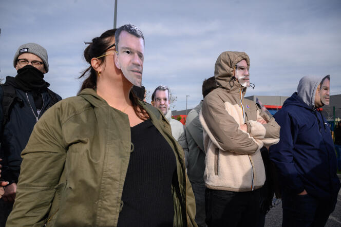 Des employés de Brico Privé manifestent devant l’entreprise, à Toulouse, le 25 mars 2024, en portant des masques reproduisant le visage de Thierry Cotillard, le dirigeant du groupe Les Mousquetaires.