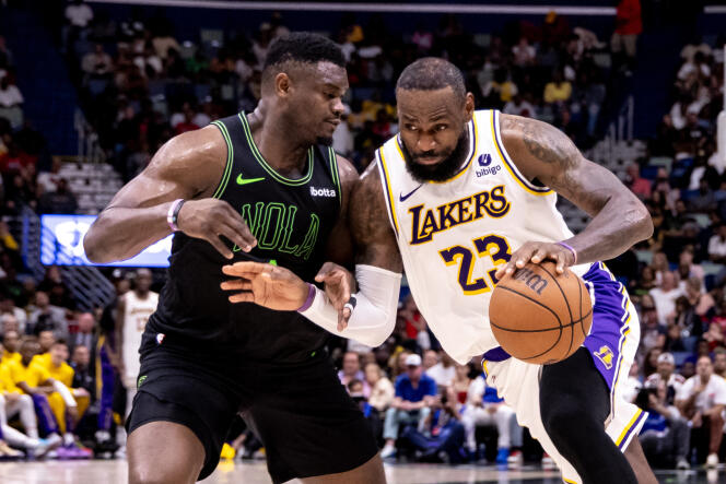 Los Angeles Lakers forward LeBron James dribbles against New Orleans Pelicans forward Zion Williamson during the second half at Smoothie King Center, in New Orleans, Louisiana, on April 14, 2024.