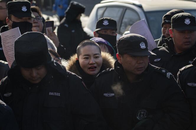 Li Wenzu (center), wife of human rights lawyer Wang Quanzhang, surrounded by law enforcement as she protests her husband's detention, outside the Hongsecun People's high court, Beijing, December 28, 2018.