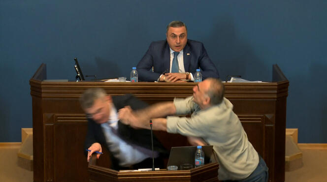 Mamuka Mdinaradze, leader of the ruling Georgian Dream party's parliamentary faction, is punched in the face by opposition MP Aleko Elisashvili, in Tbilisi, Georgia, April 15, 2024, in this still image taken from a live broadcast video. 