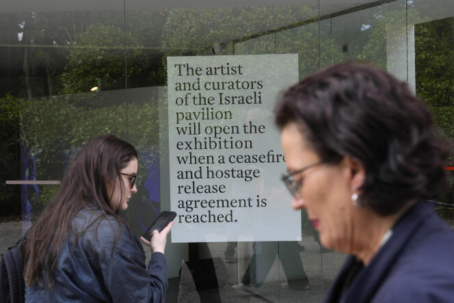 People stand in front of the closed Israeli national pavilion at the Biennale contemporary art fair in Venice, Italy, Tuesday, April 16, 2024. The sign announces that the artist and curators representing Israel at this year's Venice Biennale won't open the Israeli pavilion until there is a cease-fire in Gaza and an agreement to release hostages taken October 7. 