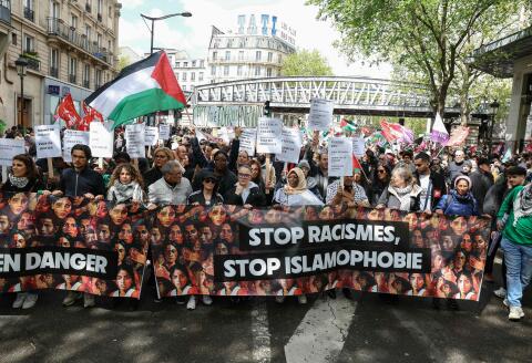 Demonstrators hold a banner reading "stop racisms, stop islamophobia" during a protest "against racism, against Islamophobia" at the call of various organisations in Paris on April 21, 2024. A court decided on April 20, 2024, to suspend a prefectoral ban on a march against racism and Islamophobia planned for April 21, 2024, in Paris, ruling that it constituted "a serious and manifestly illegal infringement of the freedom of demonstration". (Photo by Alain JOCARD / AFP)