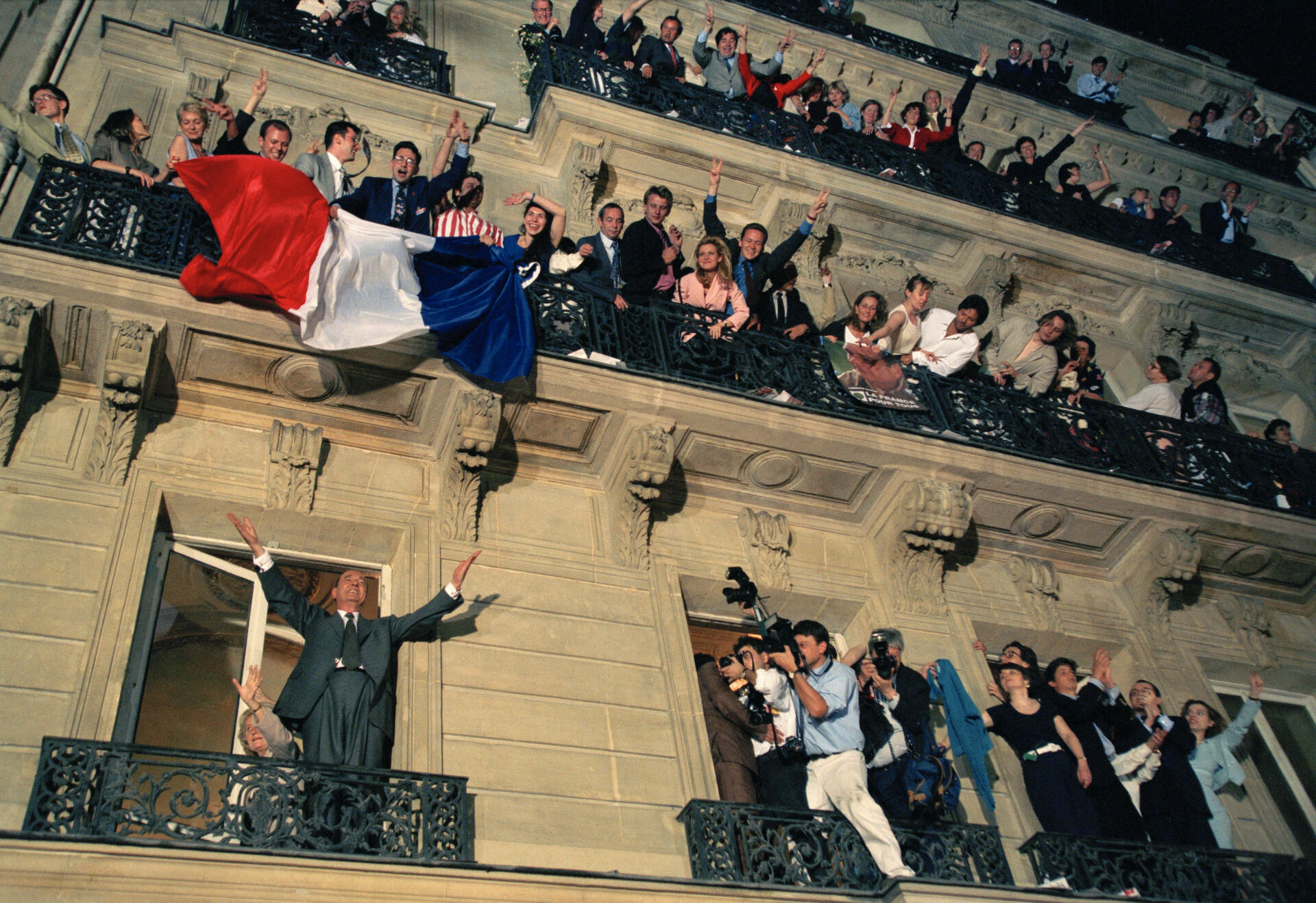 Jacques Chirac waves to the crowd from the balcony of the RPR electoral office on Avenue d'Iéna in Paris on May 7, 1995, the evening of his presidential election victory.
