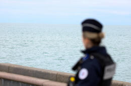 A police member looks on in Wimereux, near Calais, after migrants died in an attempt to cross the English Channel, in France, April 23, 2024. REUTERS/Yves Herman