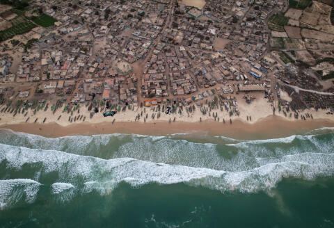A drone view shows rows of fishermen's boats, known as pirogues, on the shore at Fass Boye, Senegal, February 1, 2024. Dozens of wooden fishing boats line Fass Boye's sandy beach, a sign of fishing's central role in the local economy. But like many coastal communities, the village about 100 km north of Senegal's capital, Dakar, has seen hundreds of its residents leave in search of more opportunity. Diminishing fish stocks and soaring living costs have made it hard to make ends meet, locals say. They blame overfishing by international trawlers and say their small boats can't compete. REUTERS/Zohra Bensemra SEARCH "BENSEMRA SENEGAL FISHING" FOR THIS STORY. SEARCH "WIDER IMAGE" FOR ALL STORIES.