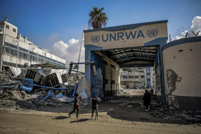 Palestinians in front of destroyed UNRWA buildings, in Gaza City, February 10, 2024.
