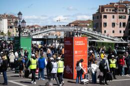 Tourists stand as they wait to pass controls and buy tickets in front of Santa Lucia train station in Venice on April 25, 2024. The new strategy to lower the number of tourists visiting the UNESCO World Heritage site calls for day-trippers to pay a five-euro ticket to enter the historic city centre and is due to start on April 25. (Photo by MARCO BERTORELLO / AFP)