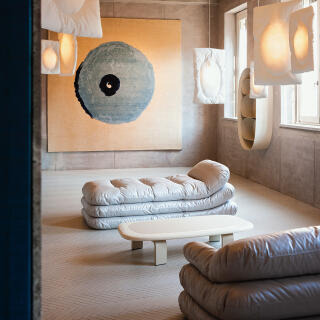 Faye Toogood, cc-tapis, and Tacchini’s Rude Arts Club. Pieces featured: A rug from Faye Toogood and cc-tapis’ Rude Collection, titled Blue Tit. 
The Solar Upholstered Daybed, the Solar Upholstered Three Seater Sofa, the Orbit Leather and Lacquered Wood Coffee Table, the Astral Metal Cabinet, and the Lunar Quilted Pendant Lights from Faye Toogood and Tacchini’s Cosmic Collection.