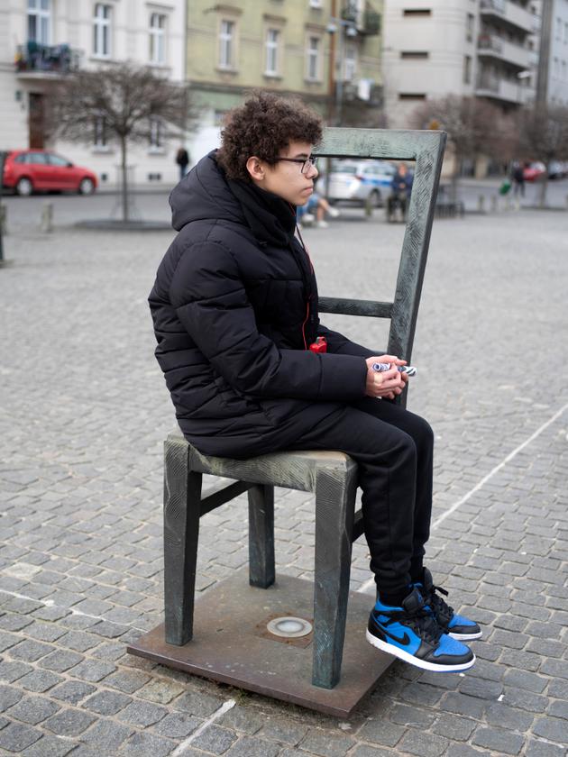 Nazim at the Ghetto Heroes' Square, a memorial made up of 68 empty chairs symbolizing the 68,000 Jews who disappeared, in Krakow, Poland, February 27, 2024.