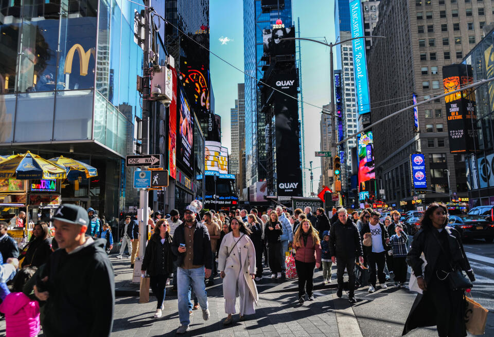 Visitors and tourists make their way through Times Square in New York City on April 7, 2024. (Photo by Charly TRIBALLEAU / AFP)