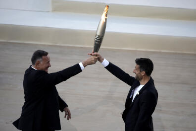 Paris 2024 Olympics - Olympic Flame Handover Ceremony - Panathenaic Stadium, Athens, Greece - April 26, 2024
President of the Hellenic Olympic Committee and member of the International Olympic Committee Spyros Capralos and Tony Estanguet, president of the Paris 2024 Olympics organising committee hold the olympic flame during the Handover Ceremony REUTERS/Louisa Gouliamaki