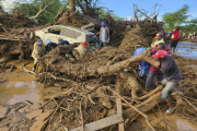 People try to clear the area after a dam burst, in Kamuchiri Village Mai Mahiu, Nakuru County, Kenya, Monday, April 29, 2024.