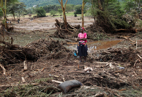 A woman watches as members of the Kenya Defence Forces (KDF) search for the bodies of missing people after flash floods wiped out several homes following heavy rains in Kamuchiri village of Mai Mahiu, Nakuru County, Kenya May 1, 2024. REUTERS/Monicah Mwangi