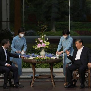 Chinese President Xi Jinping (R) and French President Emmanuel Macron (L) attend a tea ceremony at the Guandong province governor's residence in Guangzhou on April 7, 2023. (Photo by Thibault Camus / POOL / AFP)