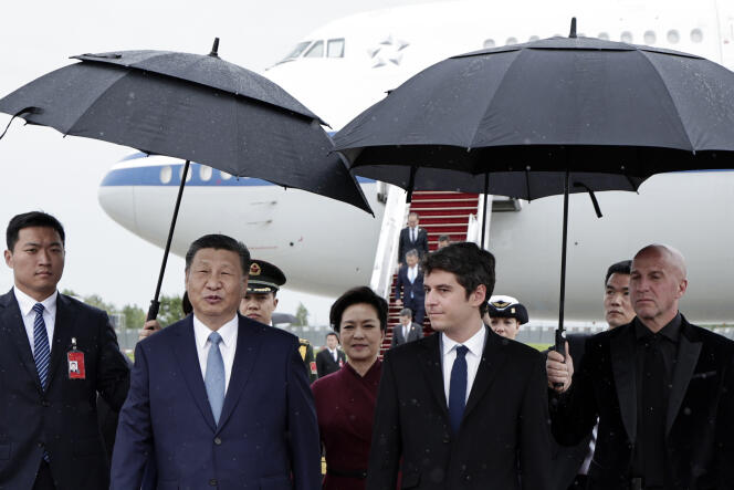 China's President Xi Jinping, center left, and his wife Peng Liyuan, center, are welcomed by French Prime Minister Gabriel Attal, left, at Orly airport, south of Paris, Sunday, May 5, 2024. 