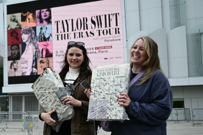 Fans of US singer Taylor Swift pose with a VIP box package, a day prior to the start of the pop star's concerts at the Paris La Defense Arena as part of her The Eras Tour, on May 8, 2024. 