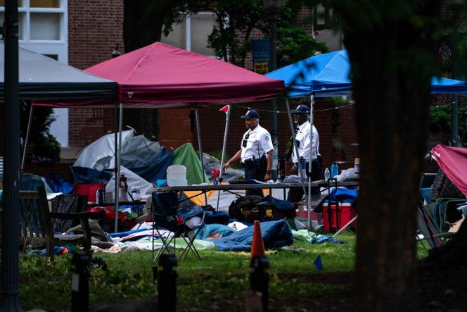 Law enforcement officers walk through a now empty pro-Palestinian protest camp at George Washington University's University Yard, on May 8, 2024, in Washington, DC.