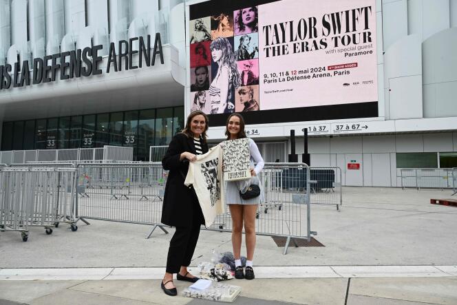 US fans of US singer Taylor Swift pose with a VIP box package, a day prior to the start of the pop star's concerts at the Paris La Defense Arena as part of her The Eras Tour, in Nanterre, north-western France, on May 8, 2024. 